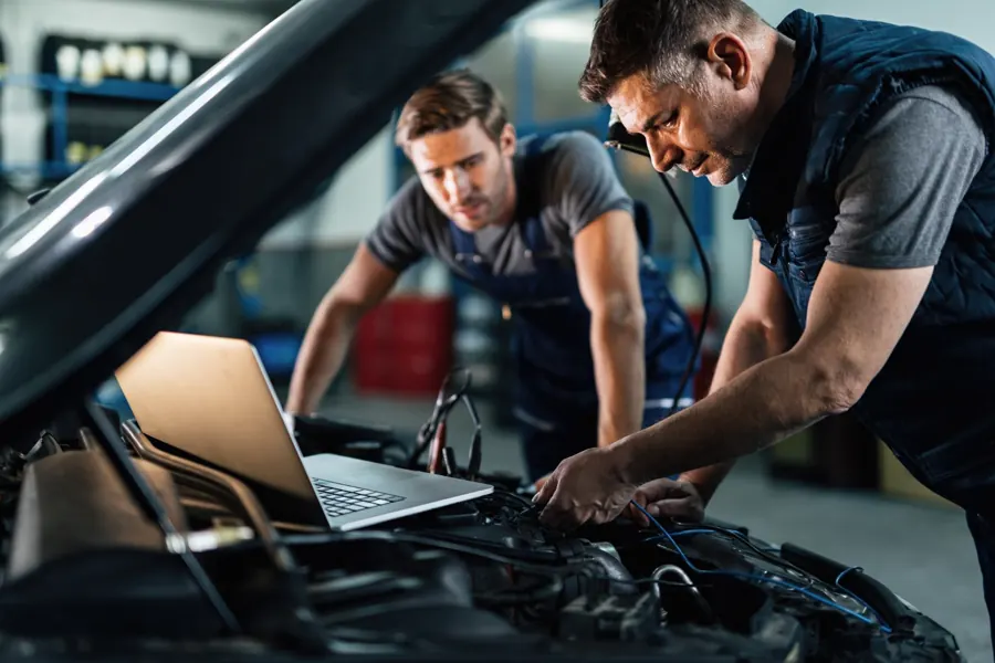 Mechanics working on a car in a workshop