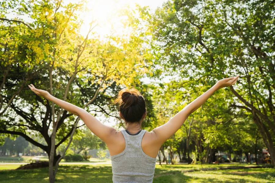 Person enjoying wellbeing outdoors